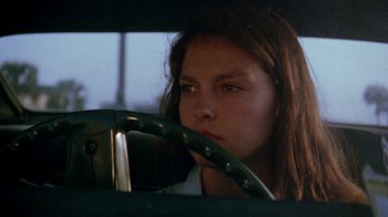 Movie still from “Ruby in Paradise” (1993), directed by Victor Nunez – A young girl sitting in the drivers seat of a car; Close Up shot, Over the shoulder angle