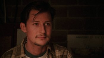 Movie still from “Ruby in Paradise” (1993), directed by Victor Nunez – A person wearing a plaid shirt; Close Up shot, Low angle