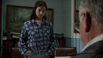 Movie still from “Ruby in Paradise” (1993), directed by Victor Nunez – A woman in a plaid shirt is standing in front of a mirror; Medium shot, Over the shoulder angle