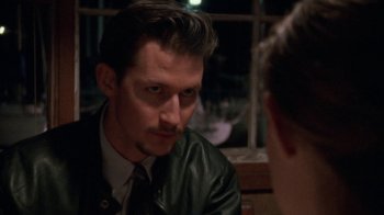 Movie still from “Ruby in Paradise” (1993), directed by Victor Nunez – A person sitting at a table; Close Up shot, Over the shoulder angle