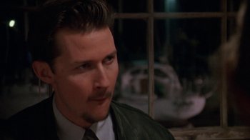 Movie still from “Ruby in Paradise” (1993), directed by Victor Nunez – A person wearing a suit and tie; Close Up shot, Over the shoulder angle