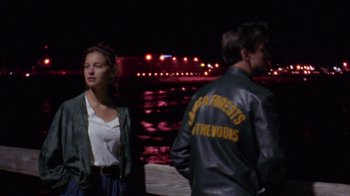 Movie still from “Ruby in Paradise” (1993), directed by Victor Nunez – A man and a woman standing next to each other near a body of water at night; Medium shot, Over the shoulder angle