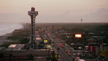 Movie still from “Ruby in Paradise” (1993), directed by Victor Nunez – An aerial view of a city with a lot of cars on the road; Extreme Wide shot, Low angle