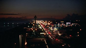 Movie still from “Ruby in Paradise” (1993), directed by Victor Nunez – An aerial view of a city at night with lights on; Extreme Wide shot, High angle