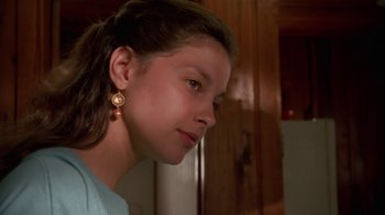 Movie still from “Ruby in Paradise” (1993), directed by Victor Nunez – A young girl with long brown hair wearing earrings; Close Up shot, Over the shoulder angle