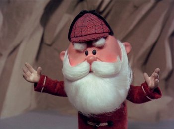 Movie still from “Rudolph the Red-Nosed Reindeer” (1964), directed by Larry Roemer – A toy santa claus wearing a hat; Close Up shot, Low angle