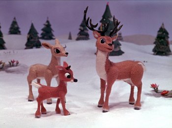 Movie still from “Rudolph the Red-Nosed Reindeer” (1964), directed by Larry Roemer – A group of stuffed deer standing next to each other in the snow; Medium shot, Low angle