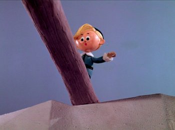 Movie still from “Rudolph the Red-Nosed Reindeer” (1964), directed by Larry Roemer – A cartoon character is standing next to a tree; Wide shot, Low angle