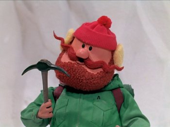 Movie still from “Rudolph the Red-Nosed Reindeer” (1964), directed by Larry Roemer – A person holding a tool and wearing a hat; Close Up shot, Low angle