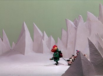 Movie still from “Rudolph the Red-Nosed Reindeer” (1964), directed by Larry Roemer – A scene of a toy soldier running across a field of snow; Extreme Wide shot, High angle