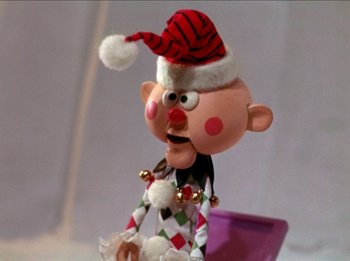 Movie still from “Rudolph the Red-Nosed Reindeer” (1964), directed by Larry Roemer – A cartoon character wearing a santa hat; Close Up shot, Low angle