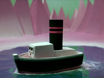 Movie still from “Rudolph the Red-Nosed Reindeer” (1964), directed by Larry Roemer – A toy boat is sitting in the middle of the water; Extreme Wide shot, High angle
