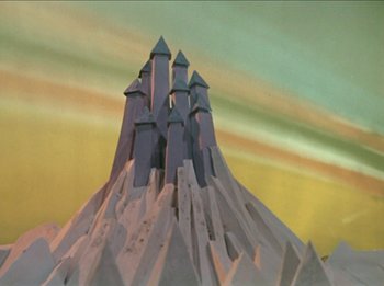 Movie still from “Rudolph the Red-Nosed Reindeer” (1964), directed by Larry Roemer – A paper model of a castle on top of a mountain; Extreme Wide shot, Low angle