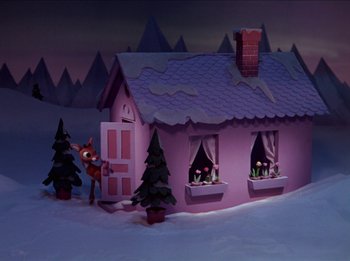 Movie still from “Rudolph the Red-Nosed Reindeer” (1964), directed by Larry Roemer – A pink house with trees in the background; Extreme Wide shot, High angle