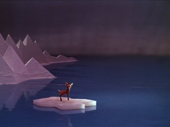 Movie still from “Rudolph the Red-Nosed Reindeer” (1964), directed by Larry Roemer – A dog standing on top of an ice floe in the middle of the ocean; Extreme Wide shot, High angle