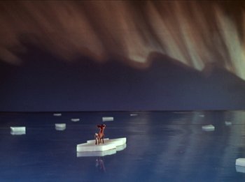 Movie still from “Rudolph the Red-Nosed Reindeer” (1964), directed by Larry Roemer – Two people sitting on an ice floe in the middle of the ocean; Extreme Wide shot, High angle