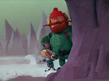 Movie still from “Rudolph the Red-Nosed Reindeer” (1964), directed by Larry Roemer – A scene of a cartoon character and a child; Medium shot, Low angle