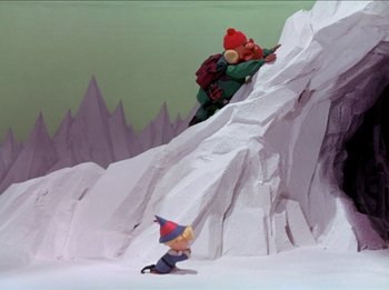 Movie still from “Rudolph the Red-Nosed Reindeer” (1964), directed by Larry Roemer – A couple of figurines are on a mountain ledge; Extreme Wide shot, High angle