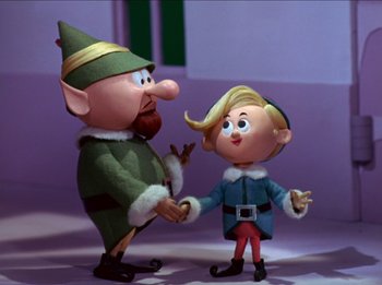 Movie still from “Rudolph the Red-Nosed Reindeer” (1964), directed by Larry Roemer – A couple of figurines are standing next to each other; Medium shot, Low angle