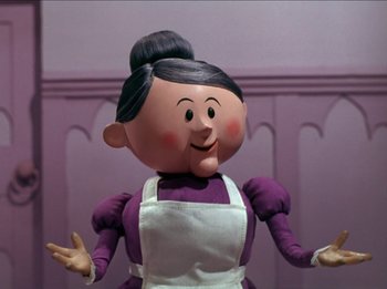 Movie still from “Rudolph the Red-Nosed Reindeer” (1964), directed by Larry Roemer – A woman in a purple shirt and white apron; Close Up shot, Low angle