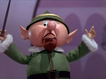 Movie still from “Rudolph the Red-Nosed Reindeer” (1964), directed by Larry Roemer – The face of an elf doll; Close Up shot, Low angle
