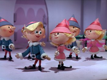 Movie still from “Rudolph the Red-Nosed Reindeer” (1964), directed by Larry Roemer – A group of small figurines of a girl and a boy; Medium shot, Low angle