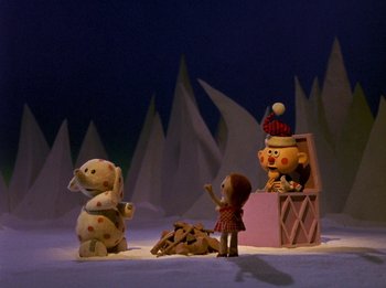 Movie still from “Rudolph the Red-Nosed Reindeer” (1964), directed by Larry Roemer – A scene of a puppet show with a teddy bear and a girl; Extreme Wide shot, Low angle