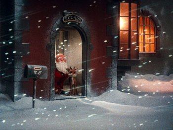 Movie still from “Rudolph's Shiny New Year” (1976), directed by Jules Bass – A santa clause and a reindeer in a snowy scene; Extreme Wide shot, Low angle