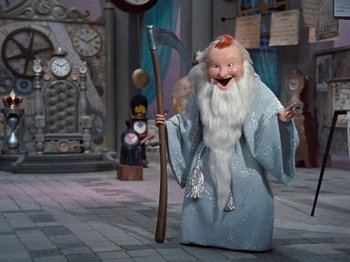 Movie still from “Rudolph's Shiny New Year” (1976), directed by Jules Bass – A doll dressed as a wizard holding an axe; Wide shot, Low angle