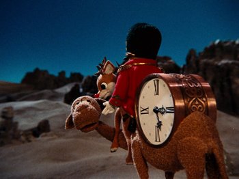 Movie still from “Rudolph's Shiny New Year” (1976), directed by Jules Bass – A stuffed animal on top of a stuffed camel; Extreme Wide shot, Low angle