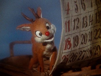 Movie still from “Rudolph's Shiny New Year” (1976), directed by Jules Bass – A stuffed animal sitting next to a calendar; Extreme Close Up shot, Low angle