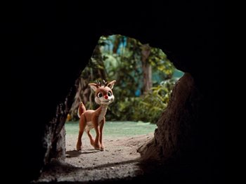 Movie still from “Rudolph's Shiny New Year” (1976), directed by Jules Bass – A toy dog standing inside of an open cave; Wide shot, Low angle