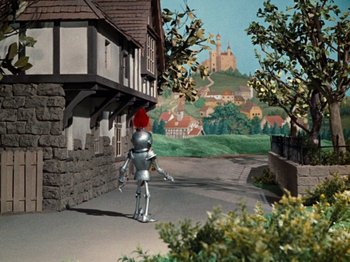 Movie still from “Rudolph's Shiny New Year” (1976), directed by Jules Bass – A scene with a castle in the background and a person in a suit of tin man; Extreme Wide shot, High angle