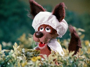 Movie still from “Rudolph's Shiny New Year” (1976), directed by Jules Bass – A stuffed animal dog wearing a white hat; Close Up shot, High angle