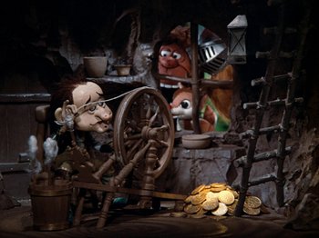 Movie still from “Rudolph's Shiny New Year” (1976), directed by Jules Bass – A scene of a puppet show in a cave; Wide shot, Low angle