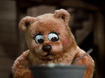 Movie still from “Rudolph's Shiny New Year” (1976), directed by Jules Bass – A teddy bear with big eyes is looking at the camera; Close Up shot, High angle