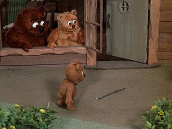Movie still from “Rudolph's Shiny New Year” (1976), directed by Jules Bass – Two brown teddy bears and a brown teddy bear in a house; Wide shot, High angle