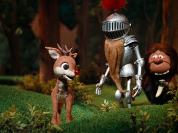 Movie still from “Rudolph's Shiny New Year” (1976), directed by Jules Bass – A reindeer and a knight in a field; Wide shot, High angle