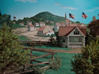 Movie still from “Rudolph's Shiny New Year” (1976), directed by Jules Bass – A painting of an american town in the middle of the day; Extreme Wide shot, High angle