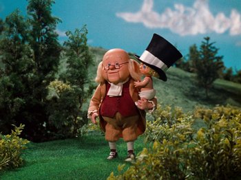 Movie still from “Rudolph's Shiny New Year” (1976), directed by Jules Bass – A cartoon of a man and a child in a field; Medium shot, Low angle