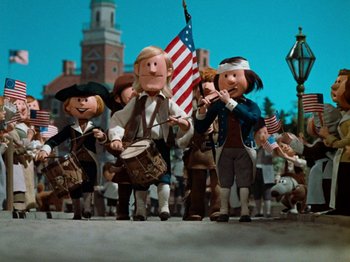 Movie still from “Rudolph's Shiny New Year” (1976), directed by Jules Bass – A group of people dressed in american costumes; Wide shot, Low angle