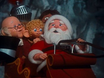 Movie still from “Rudolph's Shiny New Year” (1976), directed by Jules Bass – A toy santa claus in a sleigh; Close Up shot, Low angle