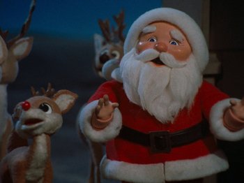 Movie still from “Rudolph's Shiny New Year” (1976), directed by Jules Bass – A santa clause and a reindeer are in a room together; Medium shot, Low angle