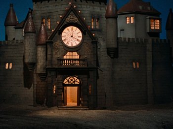 Movie still from “Rudolph's Shiny New Year” (1976), directed by Jules Bass – A castle with a clock on the front of it; Extreme Wide shot, Low angle