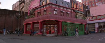 Movie still from “Rumble in the Bronx” (1995), directed by Stanley Tong – A building that has a lot of graffiti on it; Wide shot, High angle
