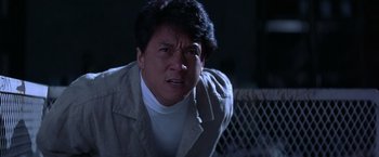 Movie still from “Rumble in the Bronx” (1995), directed by Stanley Tong – A man in a tan jacket is looking at the camera; Close Up shot, Low angle