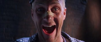 Movie still from “Rumble in the Bronx” (1995), directed by Stanley Tong – A person with a bandage on his face; Close Up shot, Low angle