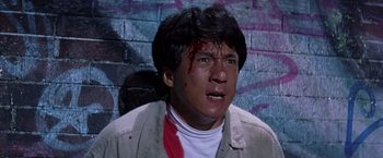Movie still from “Rumble in the Bronx” (1995), directed by Stanley Tong – A person with blood on his face; Close Up shot, Low angle