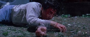 Movie still from “Rumble in the Bronx” (1995), directed by Stanley Tong – A man with blood all over his face and body; Medium shot, High angle