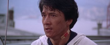 Movie still from “Rumble in the Bronx” (1995), directed by Stanley Tong – A person with a bandage on his face; Close Up shot, Low angle